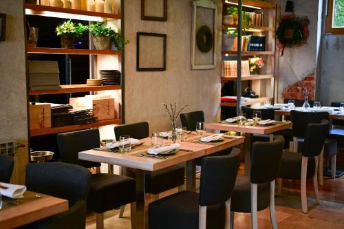 a dining room with wooden tables and chairs at Pod Zidom Rooms in Zagreb