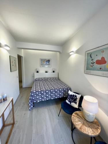 a small bedroom with a bed and a table at Salty Dreams Manarola in Manarola