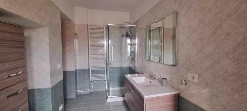 a bathroom with a sink and a shower with a mirror at Pollino House in Morano Calabro