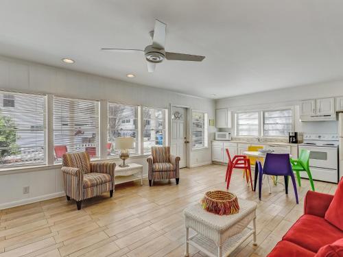 a living room with a red couch and chairs at Coops Retreat in Tybee Island