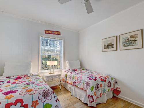 a bedroom with two beds and a window at Coops Retreat in Tybee Island