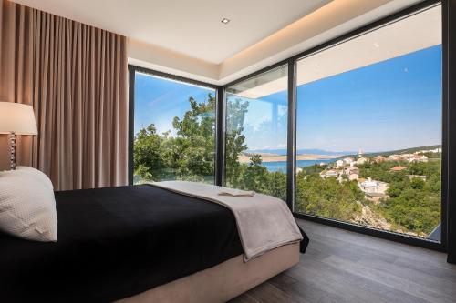 een slaapkamer met een bed en grote ramen bij Luxury Villa Cloer, Jadranovo - NEW 5 star Villa 100m from the sea in Jadranovo