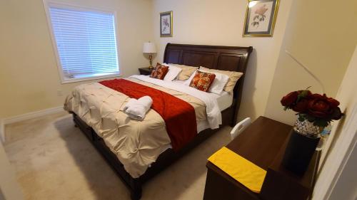 a bedroom with a large bed and a window at Beautiful Master Bedroom, TV, Wi-fi, Laundry, Parking in Cambridge