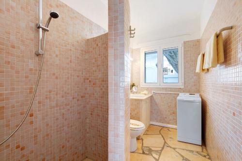 a bathroom with a shower and a toilet and a sink at Casa Campana in Costa Calma