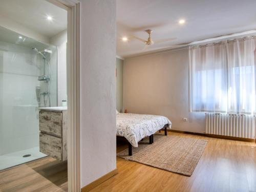 a bedroom with a bed and a shower and a sink at Casa Villa Palafrugell 1506 in Palafrugell