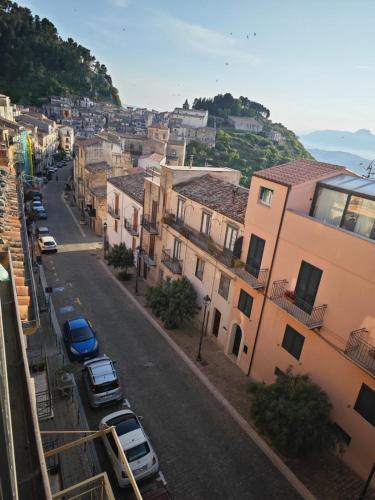 a city street with parked cars and buildings at Gratteri Holiday Appartamento Vista Mari in Gratteri