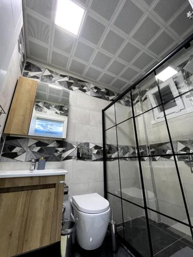 a bathroom with a toilet and a sink at Dereli Suit Delux Ayder in Rize