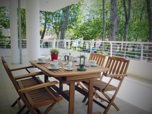 a wooden table and two chairs on a porch at Casa Baroncini Appartamenti in Cervia
