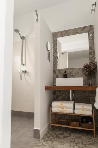 a bathroom with a sink and a mirror at Rosario17 by 7Escalones in Rota