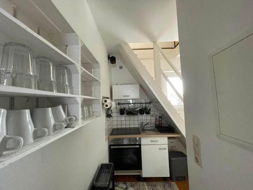 a kitchen with white cabinets and shelves with utensils at Barbarosa 3 Zimmer Rüsselsheim Baucheim 105qm in Bauschheim