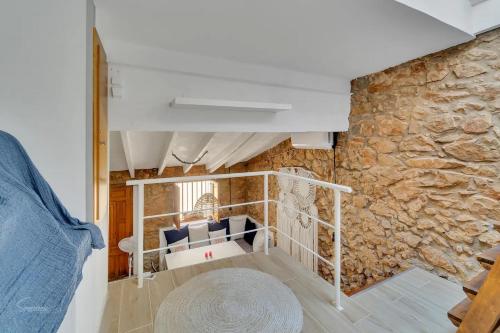 a living room with a stone wall at Casa Castillo. in Denia