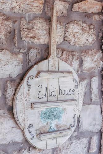 a sign for a old house on a stone wall at Elia House 2 near Nafpaktos in Lóngos