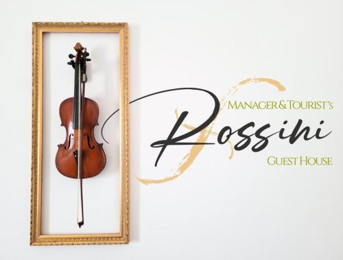 a violin in a picture frame and a sign for a violinist at ROSSINI GUEST HOUSE in Martina Franca
