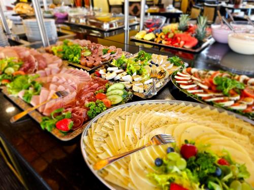a buffet with many plates of food on a table at Alexa Hotel in Göhren