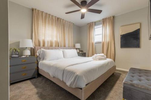 a bedroom with a bed and a ceiling fan at Maple Heights Retreat in Maple Heights