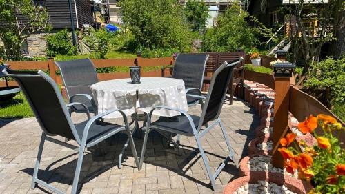 a table and chairs sitting on a patio at Ferienwohnung-direkt-am-Skihang mit Sauna in Kurort Oberwiesenthal