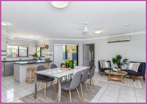 a kitchen and living room with a table and chairs at Mount Louisa Magic in Ross River