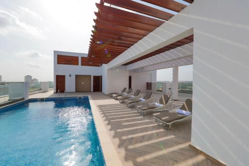 a swimming pool with lounge chairs in a building at The Gallery by Luxury Stay in Accra