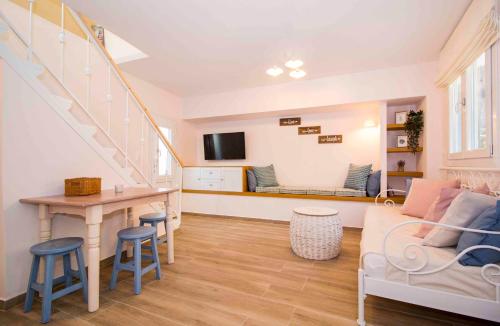 a living room with a couch and a table at Cosy House in the Heart of Gytheio in Gythio