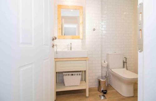 a bathroom with a sink and a toilet at Cosy House in the Heart of Gytheio in Gythio