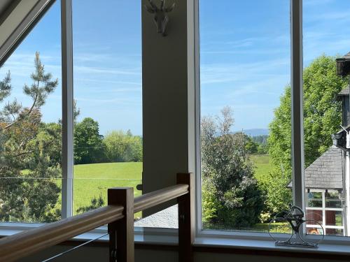 a window with a view of a green field at Newton Bothy in Stirling