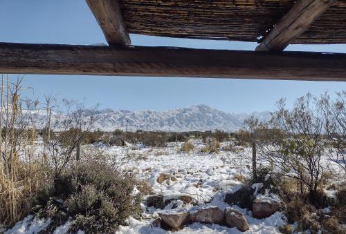 a view of a snowy field with mountains in the background at Casa Entelequia in Las Compuertas