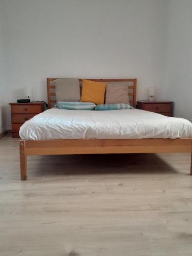 a bed with two pillows on it in a bedroom at Casa Fonte in Santo Estêvão