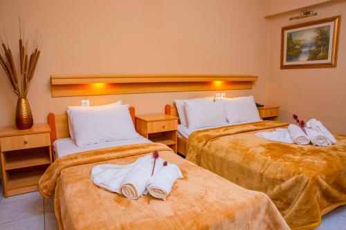 a hotel room with two beds with towels on them at THEMIS BEACH in Paralia Katerinis