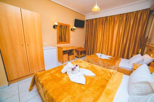 a hotel room with two beds with towels on them at THEMIS BEACH in Paralia Katerinis