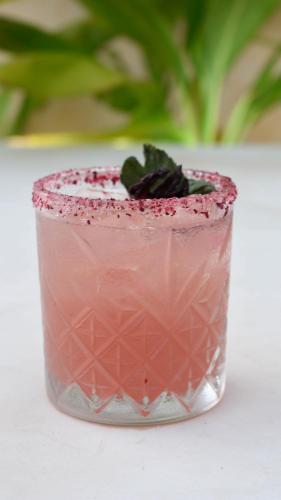 a pink drink sitting on a white table at Eterna Tulum in Tulum