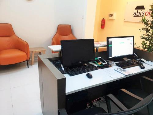 an office with a desk with a computer on it at Abi's Place in Tungan Ali