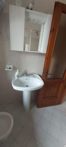 a bathroom with a sink and a mirror and a toilet at CASA SAN MICHELE in Bovegno
