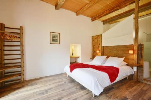une chambre avec un grand lit blanc et du parquet dans l'établissement La Mélézière-Ecrin Appartement 4 étoiles 120m2 6 personnes plein sud, aux Orres