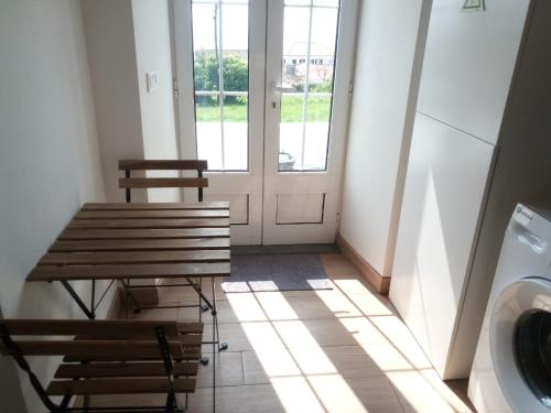 a laundry room with a table and a washing machine at Fazenda Apartments - Apartment 3 in Lajes das Flores