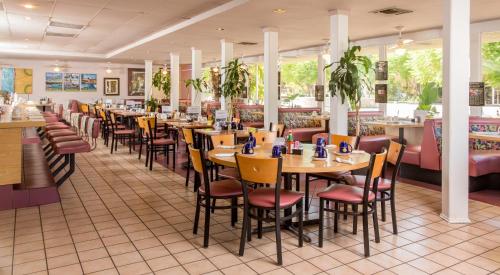 a dining room filled with tables and chairs at Days Inn by Wyndham Palm Springs in Palm Springs