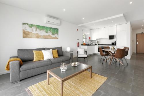 a living room with a couch and a table at Nazaré Seashell House in Nazaré