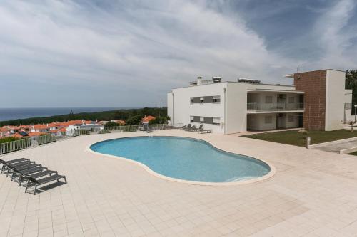 a swimming pool on the roof of a building at Nazaré Seashell House in Nazaré
