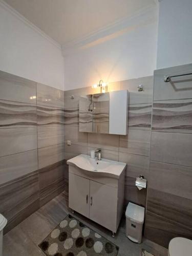 a bathroom with a sink and a toilet at Corfu Town Cozy Apartment in Ágios Rókkos
