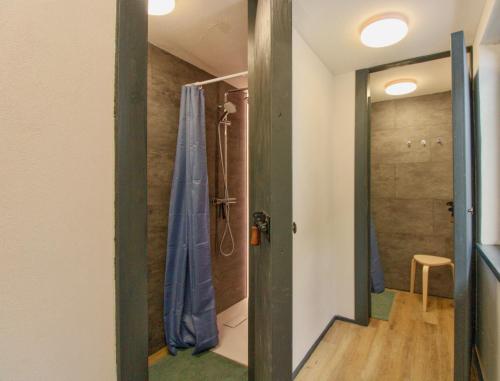 a bathroom with a shower and a shower curtain at Backyard Mountain Hostel in Mayrhofen