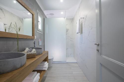 a bathroom with two sinks and a shower at Panoutsis Villa - Sivros Lefkada in Sívros