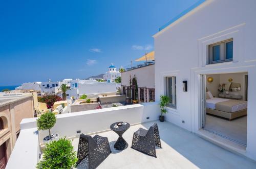 a balcony with a view of a bedroom at La Madeleine Oia in Oia