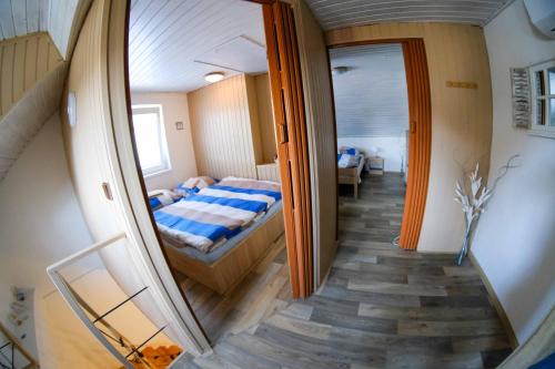 a small bedroom with a bed and a mirror at Apartmány Neronet in Velké Pavlovice