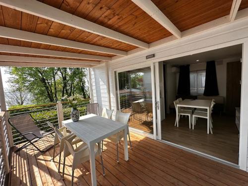 a patio with a table and chairs on a deck at Camping San Michele in Moniga