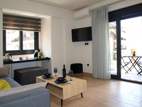 a living room with a couch and a table at Volos Terra Deluxe Residences in Volos