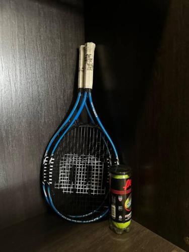 a tennis racket sitting on a table next to a can at Casa Bella Vista @ Pyramid Point in Ocho Rios