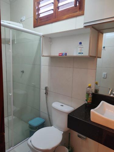 a bathroom with a toilet and a sink and a shower at Casa de praia - Trairí CE in Trairi