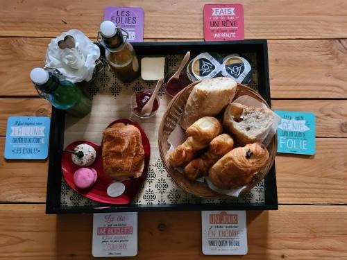 a table topped with a basket of bread and pastries at HAPPY SPA in Gouy-en-Gohelle