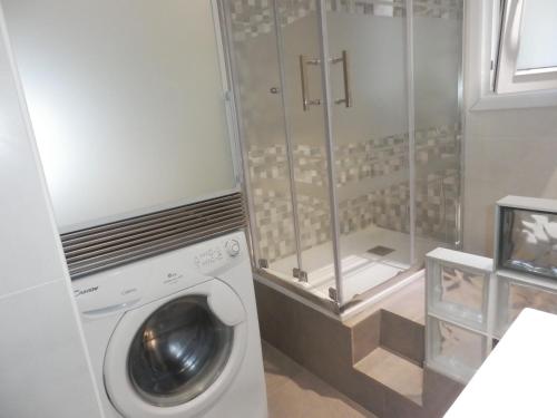 a laundry room with a washing machine and a shower at Bilbao céntrico 1h Zumaia in Bilbao