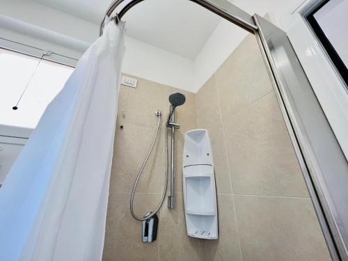 a shower in a bathroom with a shower curtain at Atmosfere di mare in Marina di Ragusa