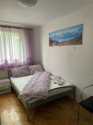 een kleine slaapkamer met een bed met schoenen erop bij Slatka sobica za dvoje sa upotrebom zajednicke kuhinje i kupaonice in Zagreb